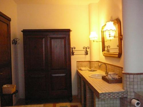 a bathroom with a sink and a wooden cabinet at Agriturismo Ca' di Mazza in Monzuno