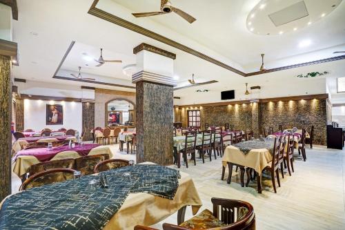 a restaurant with tables and chairs in a room at Palette - Pagoda Resorts in Cochin