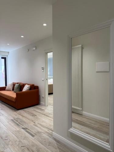 a living room with a couch and a large mirror at Ines Apartments in Giardini Naxos