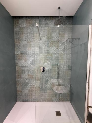 a bathroom with a shower with a glass door at Ines Apartments in Giardini Naxos