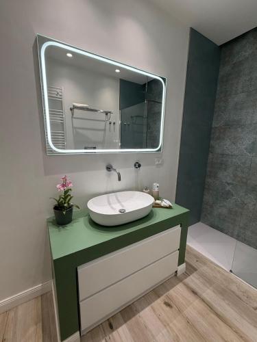 a bathroom with a sink and a mirror at Ines Apartments in Giardini Naxos