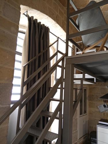 a ladder leading up to a loft in a building at Monolocale prezioso in Trani