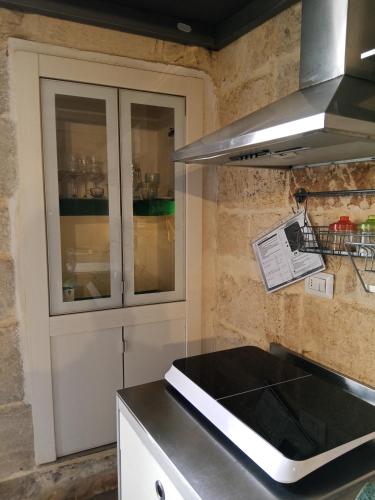 a kitchen with a sink and a counter top at Monolocale prezioso in Trani