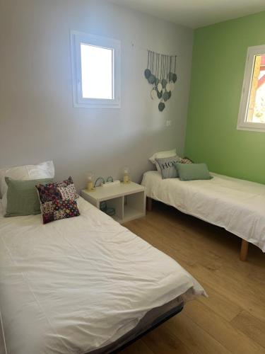 una habitación con dos camas y una ventana en Gîte Bortü Lilia, en Aroue