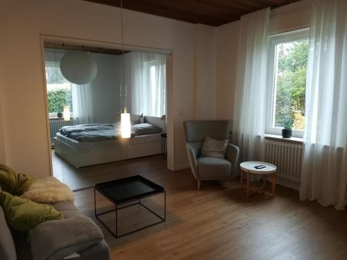 a bedroom with a bed and a couch and a table at Renovierte Wohnung zentral in Lemgo in Lemgo