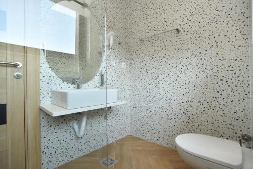 a bathroom with a sink and a mirror at Apartments Jadranski Biser in Čanj