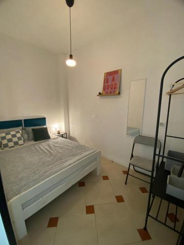 a bedroom with a bed and a chair in it at Apartament Hana in Golem