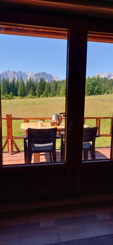 a view of a table and chairs from a window at Etno SELO Uskoci in Uskoci
