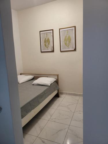 Ένα ή περισσότερα κρεβάτια σε δωμάτιο στο Residence Naim