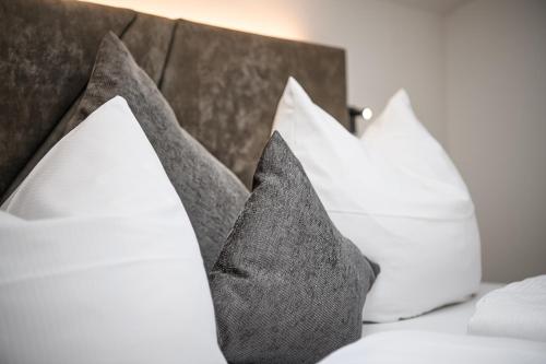 a group of pillows sitting on top of a bed at Hotel Hubertushof in Grossarl