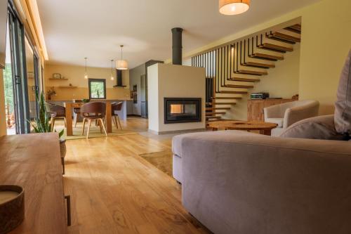 a living room with a couch and a fireplace at Quinta da Fenteira - Casa Lima in São Jorge