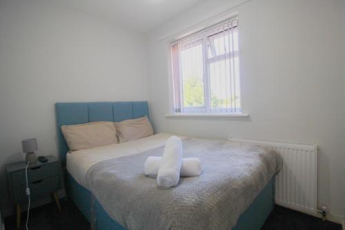 a bedroom with a bed with two towels on it at Budget Room in Wolverhampton in Coseley