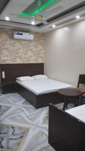 a room with two beds and a table in it at Sylhet Plaza in Sylhet