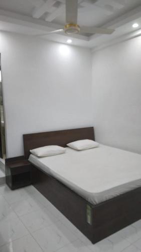 a bed in a room with a ceiling at Sylhet Plaza in Sylhet