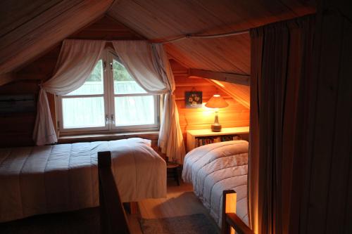 a bedroom with two beds and a window at Liinaranta in Kalmari