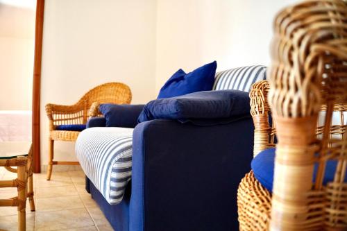a blue couch with blue pillows on it in a room at Suite & Sea - Apulian Stay Group in Rome
