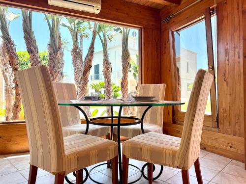 a dining room with a glass table and two chairs at Suite & Sea - Apulian Stay Group in Rome