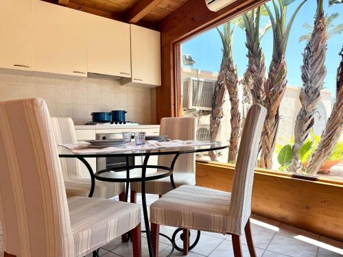 a kitchen with a table and chairs and a window at Suite & Sea - Apulian Stay Group in Rome
