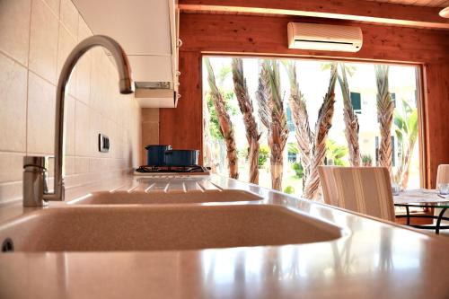 a kitchen counter with a sink and a window at Suite & Sea - Apulian Stay Group in Rome