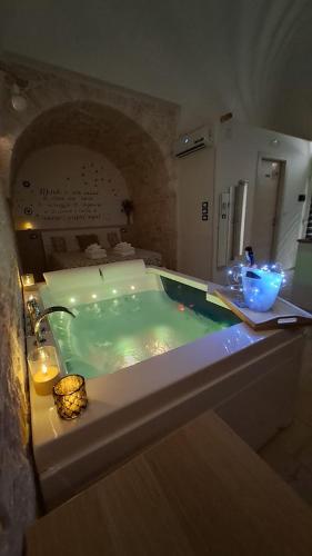 a bathroom with a bath tub with a sink at Pampa Puglia B&B in Turi