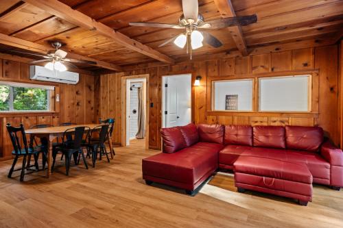 a living room with a couch and a table at Arbutus l Bonfires l Beach l Lakefront l Pets OK! in Traverse City