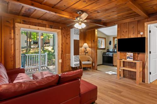 a living room with a couch and a flat screen tv at Arbutus l Bonfires l Beach l Lakefront l Pets OK! in Traverse City