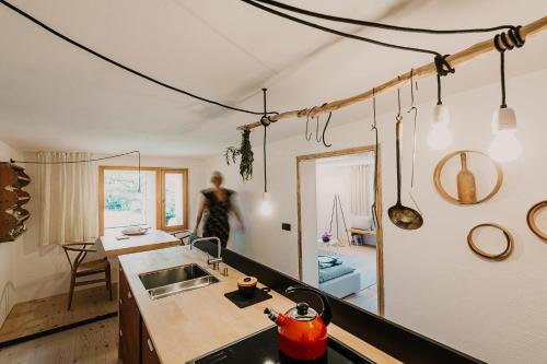 a woman is standing in the kitchen of a house at Haidl-Madl Ferien und Wohnen in Haidmühle
