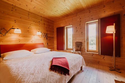 a bedroom with a bed in a wooden room at Haidl-Madl Ferien und Wohnen in Haidmühle
