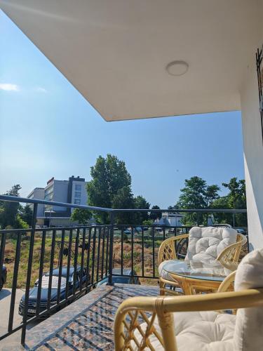 a balcony with chairs and a table on a balcony at Seven Studio in Saturn