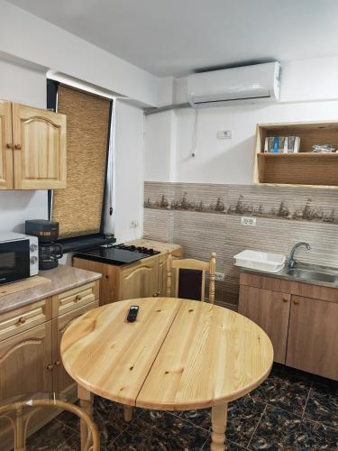 a wooden table in the middle of a kitchen at Seven Studio in Saturn