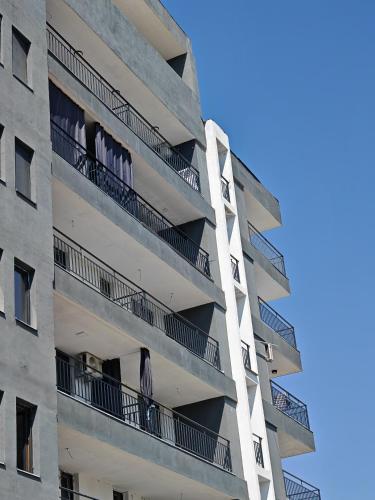 an apartment building with balconies on the side of it at Seven Studio in Saturn