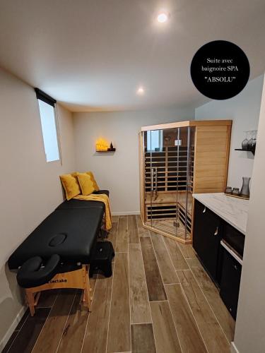 a small room with a table and a bed in it at Les Bras de Morphée in Avize