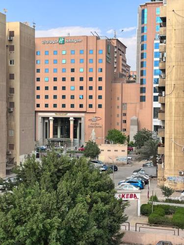 a large building with cars parked in a parking lot at الايام الجميلة in Cairo