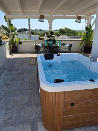 a hot tub on the roof of a house at P4T by the Sea Jacuzzi in Lendinuso