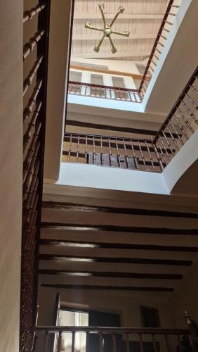a ceiling in a building with a clock on it at Casa palaciega Doña Leocadia in Viana