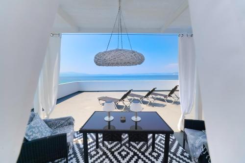 a room with a table and a view of the beach at Chrissi Seastar in Skala Sotiros