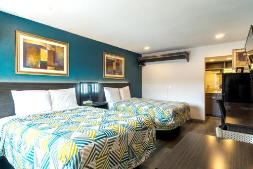 a hotel room with a bed and a television at Town Place Studio in Snyder