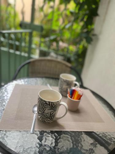 two cups of coffee sitting on a table at Vieil Antibes, ravissant 2p avec petite terrasse in Antibes