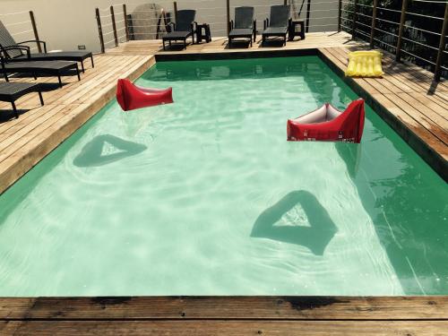 a swimming pool with red shoes in the water at Il Giardino Di Flora con Piscina & Jacuzzi in Lecce