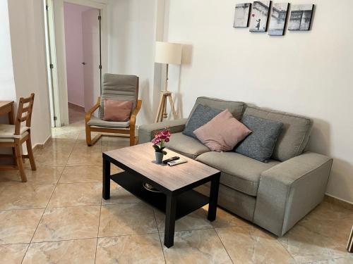 a living room with a couch and a coffee table at Apartamento sureño in Cádiz
