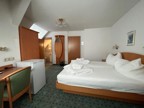 a hotel room with a bed with towels on it at Aparthotel Mariazellerhof in Sankt Pölten