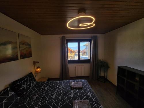 a bedroom with a large bed and a window at Le regard sur le lac in Saint-Gingolph