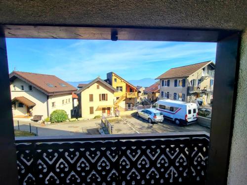 a view from a window of a town with a van at Le regard sur le lac in Saint-Gingolph