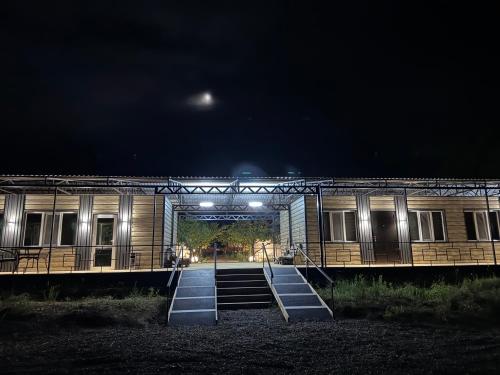 a train station at night with the lights on at BarBulak Yurt Lodge in Bar-Bulak