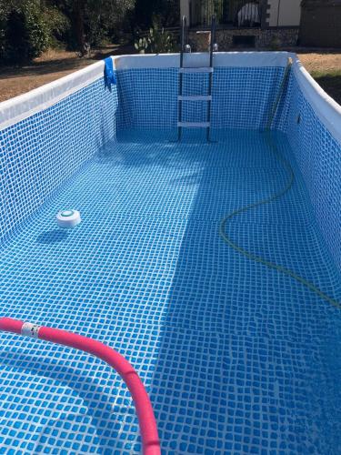 a blue tiled swimming pool with a net in it at Villa Celestina, a 10 minuti dalle Terme in Vetralla