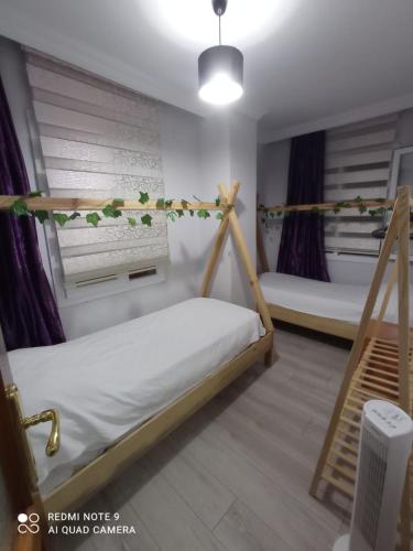 a room with two bunk beds and a staircase at Can’s Homes in Kuşadası
