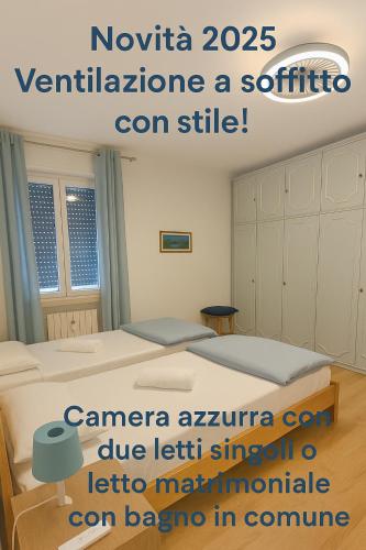 a poster of a bedroom with two beds in a room at Fiocco di Neve in Tarvisio