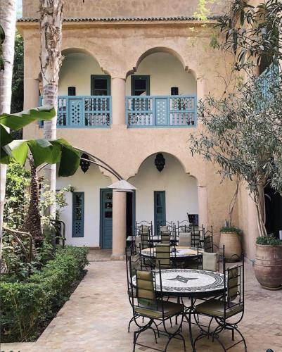 a patio with a table and chairs in front of a building at Palais Oumensour in Taroudant