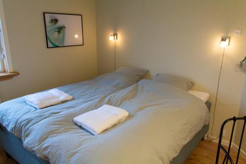 a white bed with two pillows on top of it at Spacious 220 sqm Apartment with 4 Bedrooms in Tórshavn