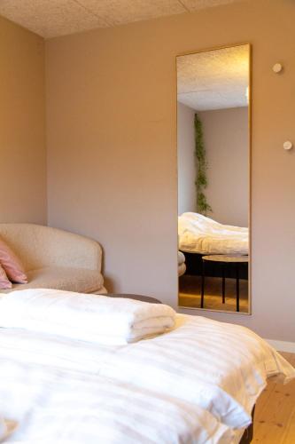 a bedroom with a bed and a mirror at Spacious 220 sqm Apartment with 4 Bedrooms in Tórshavn